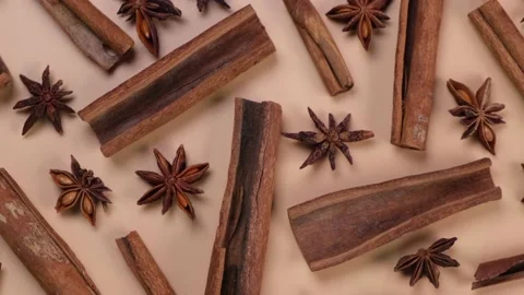 Rotation background with cinnamon sticks and anise stars on a beige background, Stock Footage 218370764