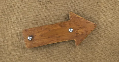 Rotation of a blank wooden pointer, arrow with two iron bolts. Top view. Stock Footage 160690019