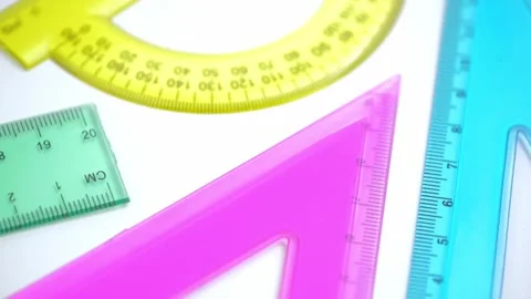 Rotation bright plastic triangle, ruler, protractor on white background. closeup Stock Footage 249188277