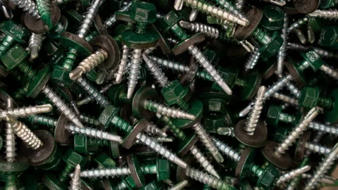 Rotation of camera around a large number of green screws. Background for text Stock Footage 98320475