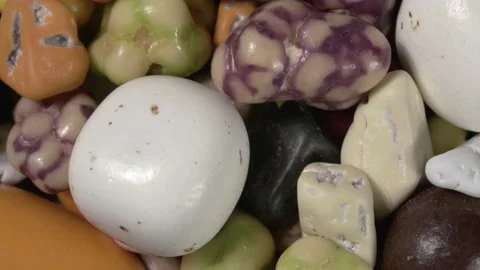 Rotation of candy pebble close-up. Nuts in caramel. Stock Footage 143730235