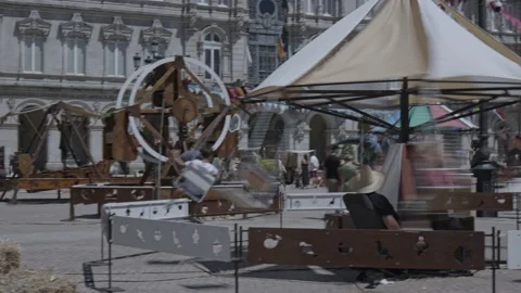 Rotation of the children's carousel in the central square of the city of A Stock Footage 232395224