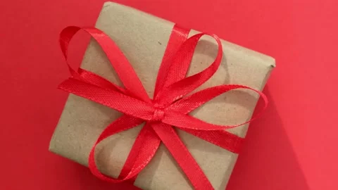 Rotation of Christmas gift box on red background. Boxing day, holiday surprise Stock-Footage 220111329