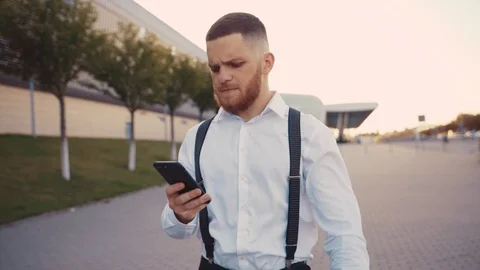 Rotation close up view of brutal bearded young ginger man walking down the alley Video stock 115669147