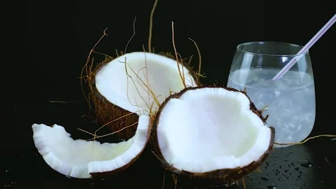 Rotation of coconut shell and white flesh, glass of milk water straw, copy space Stock Footage 155792838