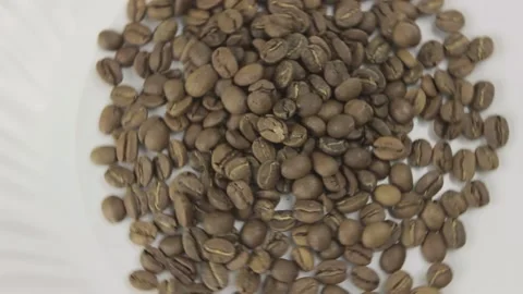 Rotation of coffee beans on a white background. Top view Stock Footage 131211327