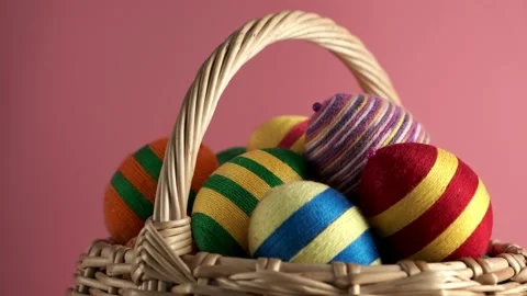 Rotation of colorful easter egg in basket made from threads Stock Footage 171750056