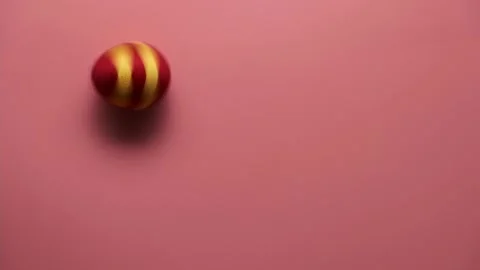 Rotation of colorful easter egg made from threads isolated on pink background. Stock Footage 166779664