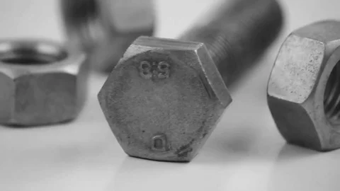 Rotation composition of steel bolt and nuts Stock Footage 70871982