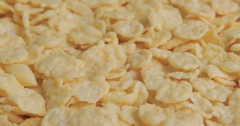 Rotation of crispy yellow corn flakes Stock Footage 99811065