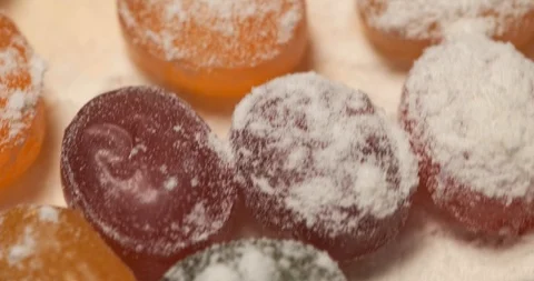 Rotation of delicious sweets, lying on rotating platform, sweets fly by camera Stock Footage 119095999