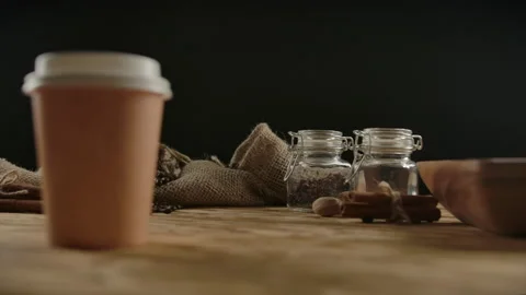 Rotation of disposable cup for hot drinks on wood table. Presentation of serving Stock Footage 136814336