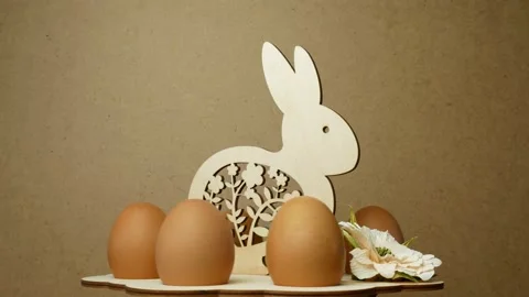 Rotation of eggs in an Easter stand made of wood on a gray background. Easter Stock Footage 233153421