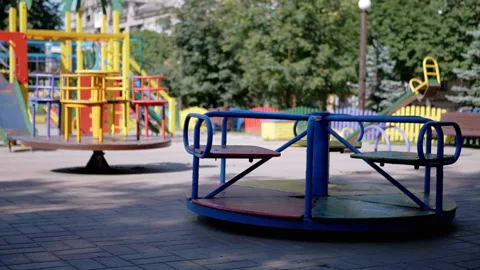 Rotation of an Empty Multicolored Carousel on a Playground in a City Park 動画素材 158877186