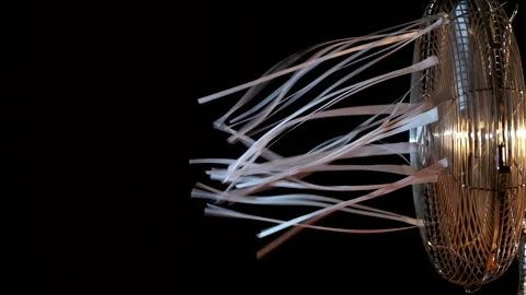 The rotation of the fan blades develops sheets of paper. Stock Footage 169750479