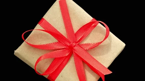 Rotation of gift box with red bow on black background. Black Friday Stock Footage 217421610