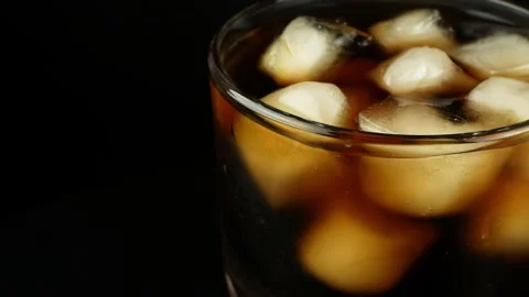 Rotation of a glass with ice cubes and a... | Stock Video | Pond5