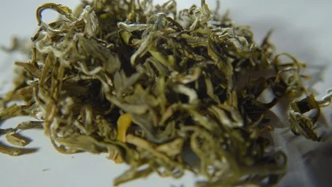 Rotation of green leafy tea on a white background Stock Footage 74450560