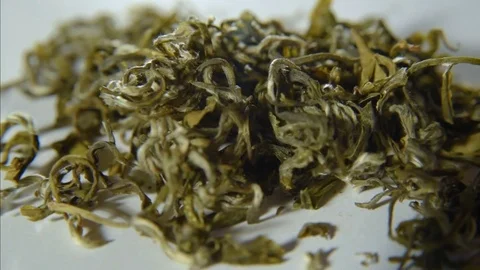 Rotation of green leafy tea on a white background Stock Footage 74450625