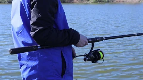 Rotation of the handle with the reel of the rod on the river. A man who loves to Stock Footage 271253868