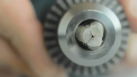 The rotation of the hands pried jaws of the drill Chuck of a drill. Stock Footage 129001723