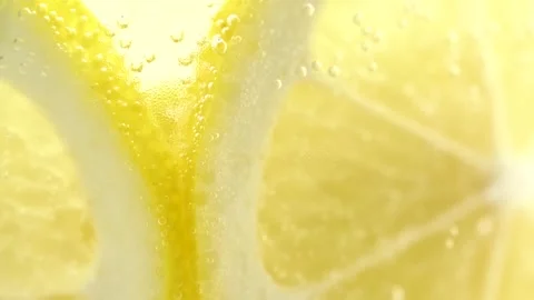 Rotation of lemonade in a glass, macro. Fruit lemon cocktail close-up textu.. Stock Footage 252069860