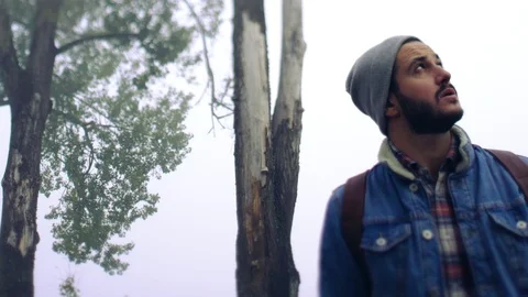 Rotation low angle portrait of anxious young bearded man in jeans jacket 스톡 동영상 108730747