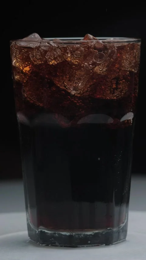 Rotation macro shot  of Cola Bubbles and Ice Cubes in a Glass Stock Footage 141809226
