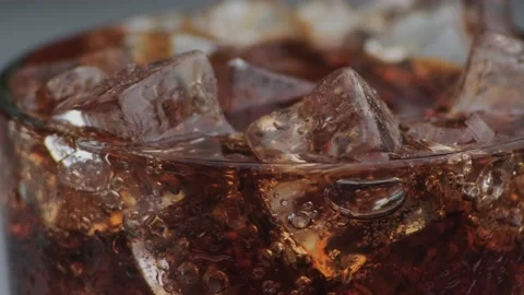 Rotation macro shot  of Cola Bubbles and Ice Cubes in a Glass. Stock Footage 141821606
