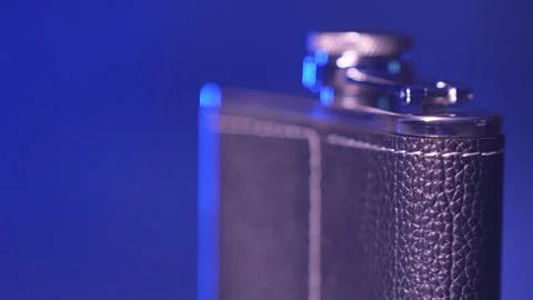 The rotation of a metal flask for alcohol Stock Footage 312604464