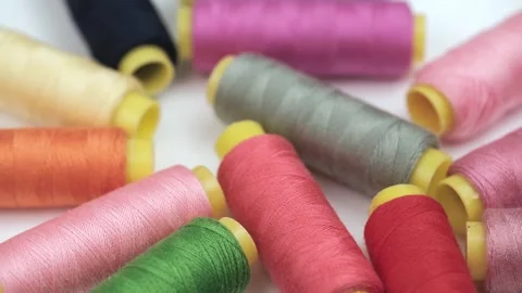 Rotation of multicolored sewing threads on coils of natural, artificial fibers. Stock Footage 252632580