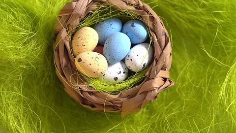 Rotation nest with easter  colorful eggs on green grass background Stock Footage 150380705
