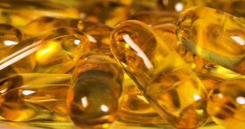 Rotation of a nutrition fish oil , rich of omega 3 supplement vitamin gel cap Stock Footage