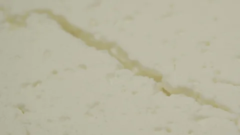 Rotation over fresh curd cheese at bright light macro Stock Footage 124667942