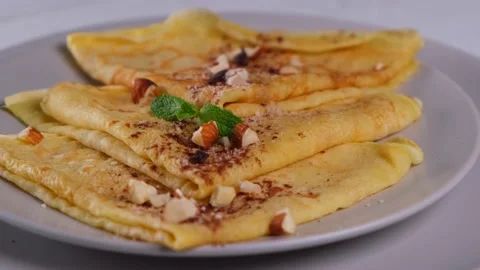 Rotation pancakes with chocolate spread and nuts, delicious breakfast Stock Footage 155689161