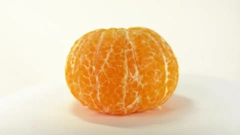 Rotation Peeled orange on white background Stock Footage 149786345