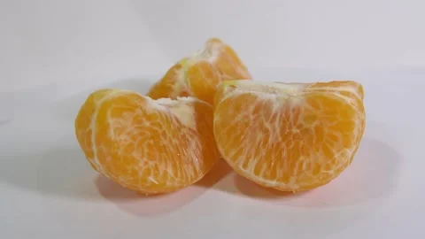 Rotation Peeled orange on white background Stock Footage 150326975