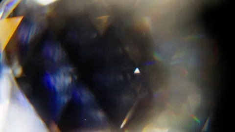 Rotation of a rainbow colored prism on a black background Stock Footage 345517428