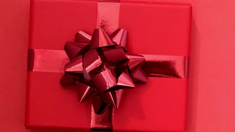 Rotation of red gift box with ribbon on red background. Jewelry store concept Stock-Footage 215849251