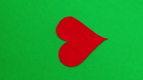 Rotation of red heart on green background. Minimalist concept for Valentines day Stock Footage 217538226