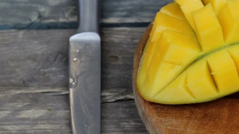 Rotation of rip mango slice cubes cut Stock Footage 129626092