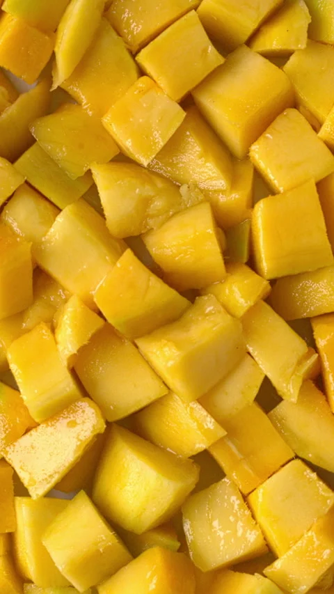 Rotation of ripe mango chunks.  Vertical video. Stock Footage 325869970