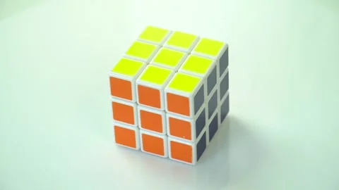 Rotation of the Rubik's Cube puzzle on a light background Stock Footage 246713694