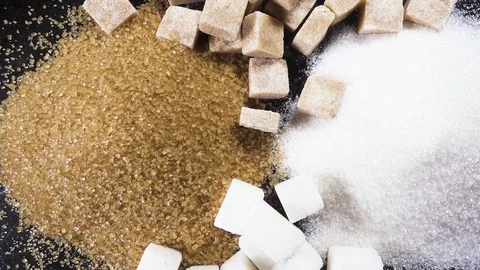 The rotation of the sugar cubes and crystal sugar top view Stock Footage 99036696