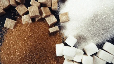 The rotation of the sugar cubes and crystal sugar top view Stock Footage 99036803