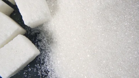 The rotation of the sugar cubes and crystal sugar top view Stock Footage 99037003