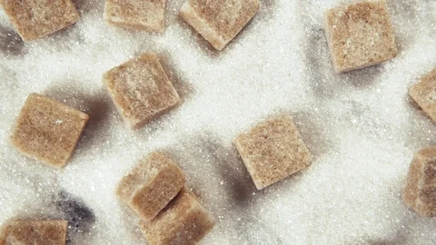 The rotation of the sugar cubes and crystal sugar top view Stock Footage 99037440