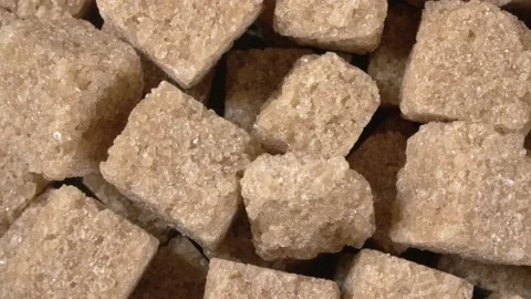 Rotation of sugar lumpy close-up. Brown sugar. Sugar cubes. Stock Footage 143786024