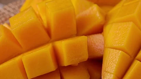Rotation of sweet mango slice cubes. Video stock 307845451