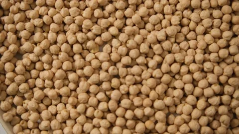 The rotation of the texture of chickpeas. Background. Rotating a plate of chickp Video stock 147871276